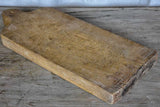 Large antique French cutting board with rounded handle and shoulders