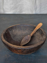 An antique French wooden bowl with repairs