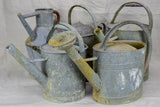 Collection of five antique zinc watering cans