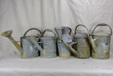 Collection of five antique zinc watering cans