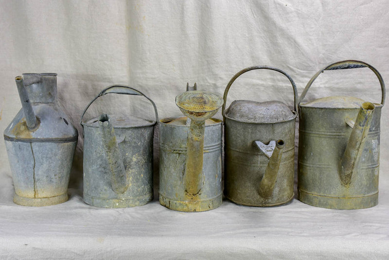 Collection of five antique zinc watering cans