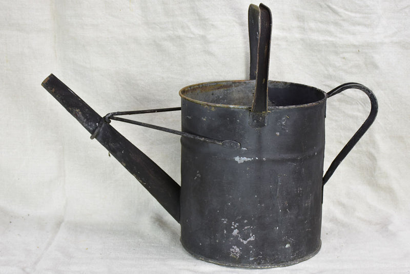 Antique English watering can with black painted finish