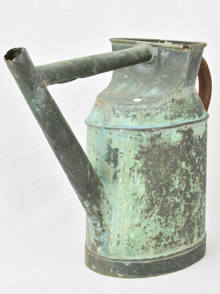 Antique French watering can with verdigris patina