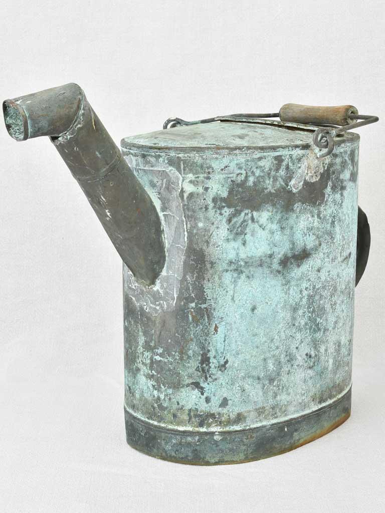 Antique French watering can with blue green atina