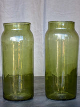 A pair of large late 19th Century green glass jars