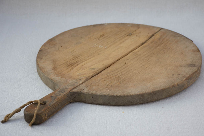 Early 20th century round cutting board branded Girard F. 20½" x 15¼"
