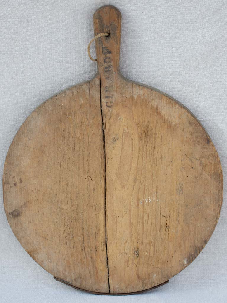 Early 20th century round cutting board branded Girard F. 20½" x 15¼"