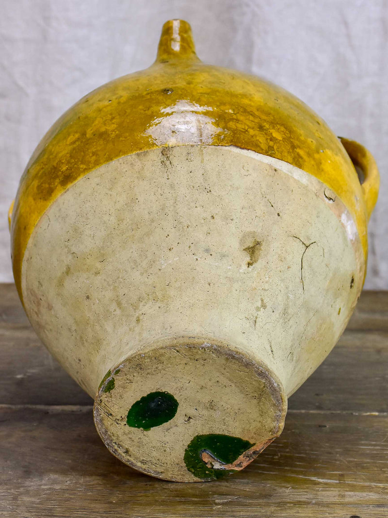 Antique French water jug with yellow and green glaze