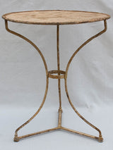 Early 20th century French garden table with ochre patina
