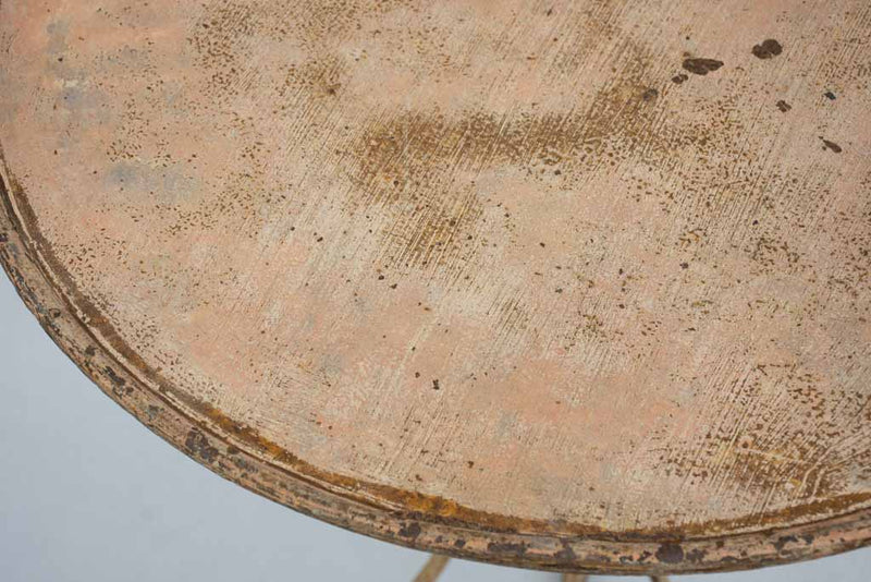 Early 20th century French garden table with ochre patina