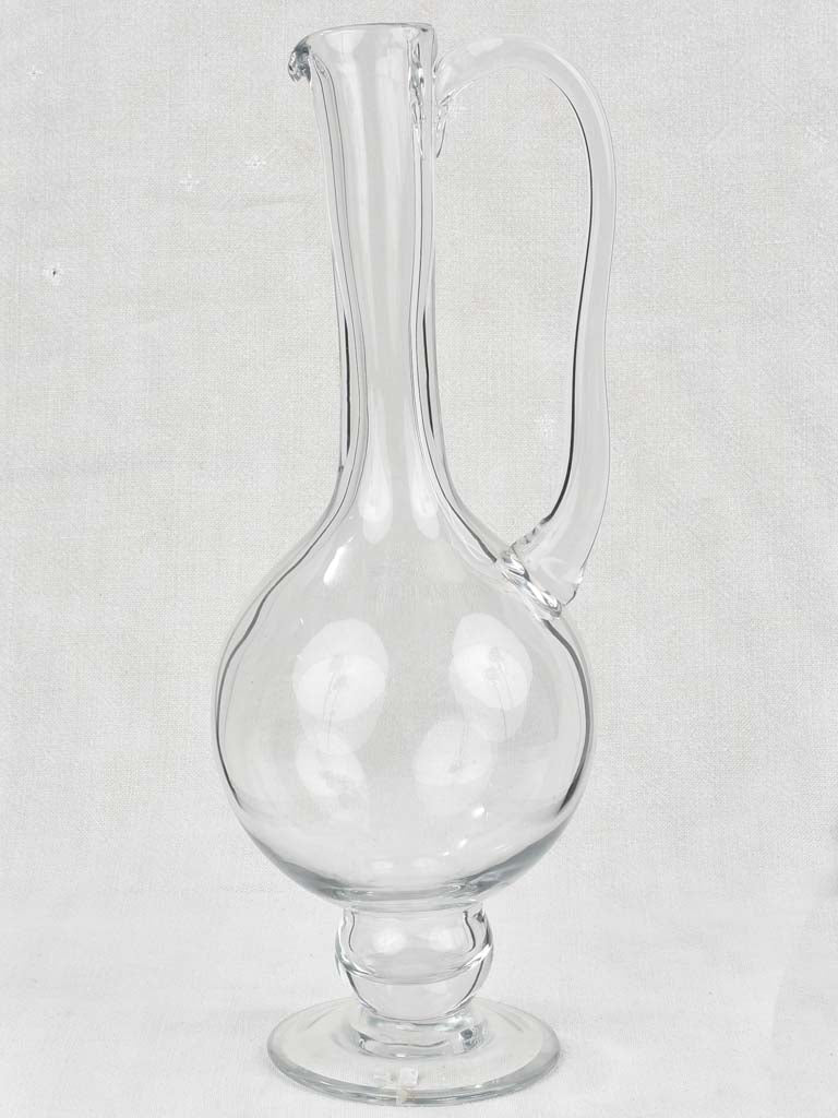 Pedestal style historical glass carafe