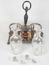 Two crystal carafes in a silver carrier
