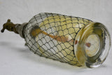 Antique French seltzer bottle in wire