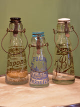 Three antique French milk bottles