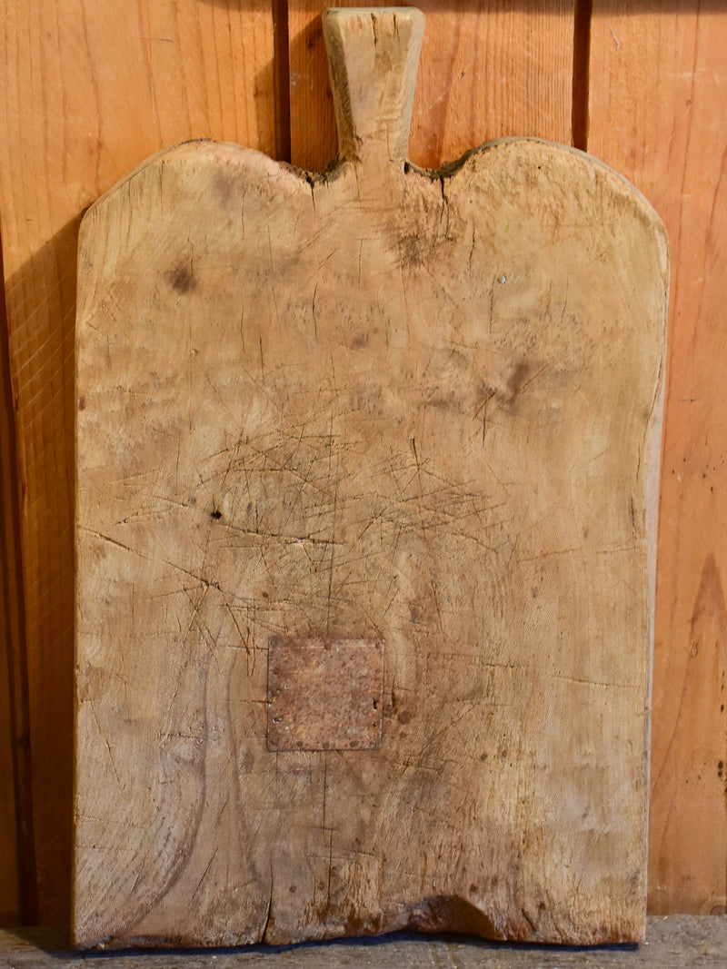 Antique French cutting board with rounded shoulders