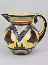 Mid-century Quimper pitcher decorated with bells and trees