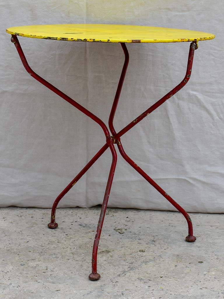 Folding antique French garden table with yellow table top and red legs