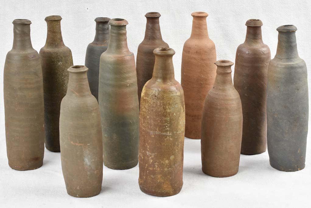 Collection of 11 antique Ger sandstone long bottles 11¾"