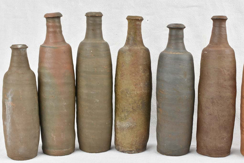 Collection of 11 antique Ger sandstone long bottles 11¾"