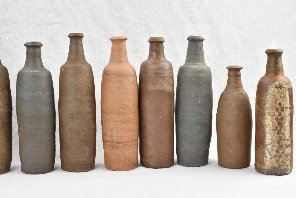 Collection of 11 antique Ger sandstone long bottles 11¾"