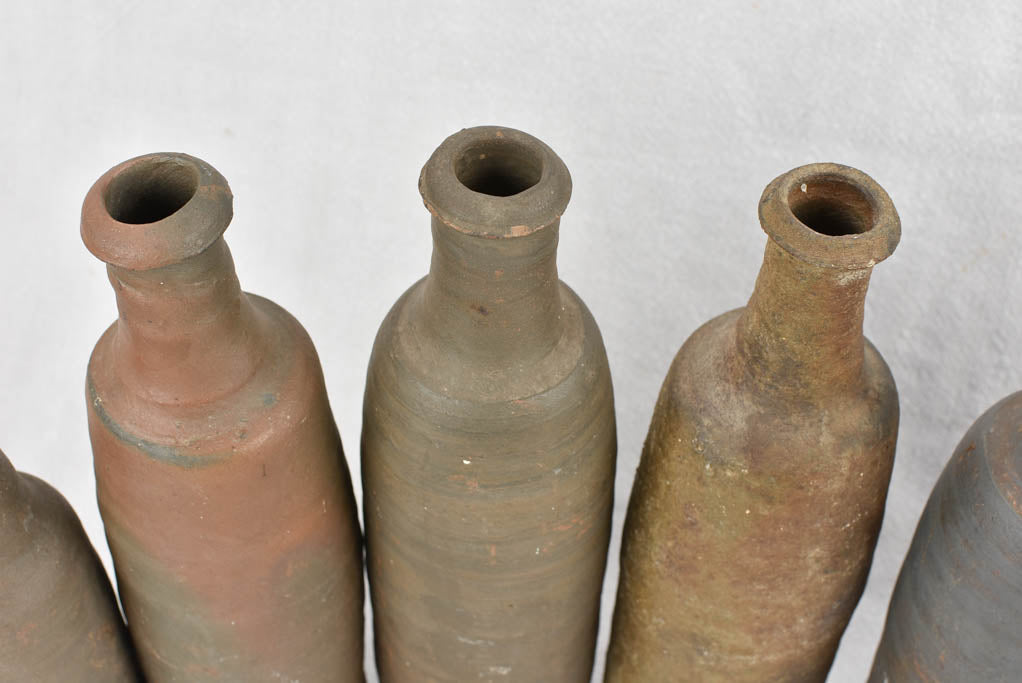 Collection of 11 antique Ger sandstone long bottles 11¾"