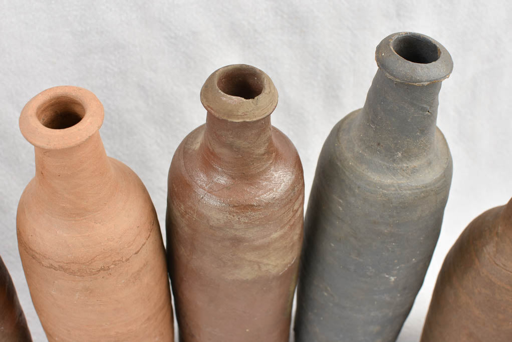 Collection of 11 antique Ger sandstone long bottles 11¾"