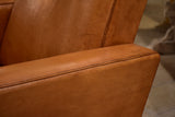 Pair of French leather armchairs in the style of Pierre Guariche
