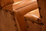 Pair of French leather armchairs in the style of Pierre Guariche