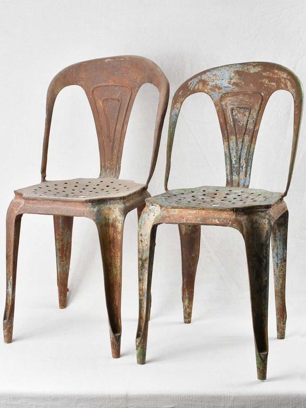 Rustic 1920s stacked Tolix style chairs