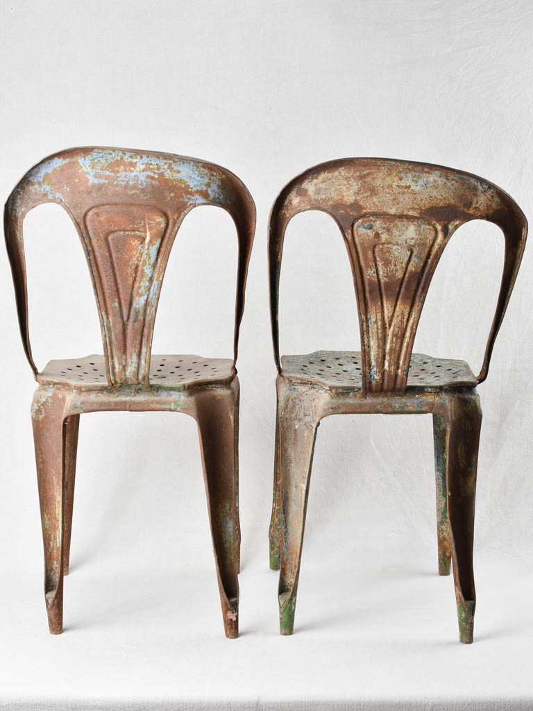 Aged patina stackable metal chairs