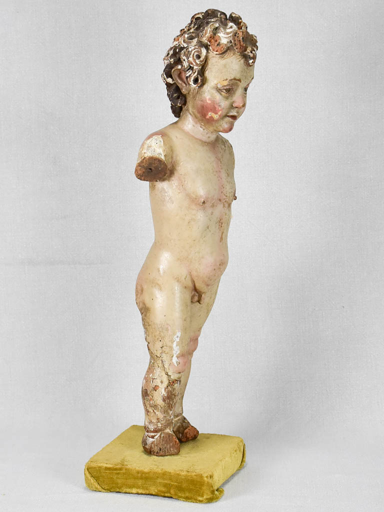 Aged painted cherub without arms