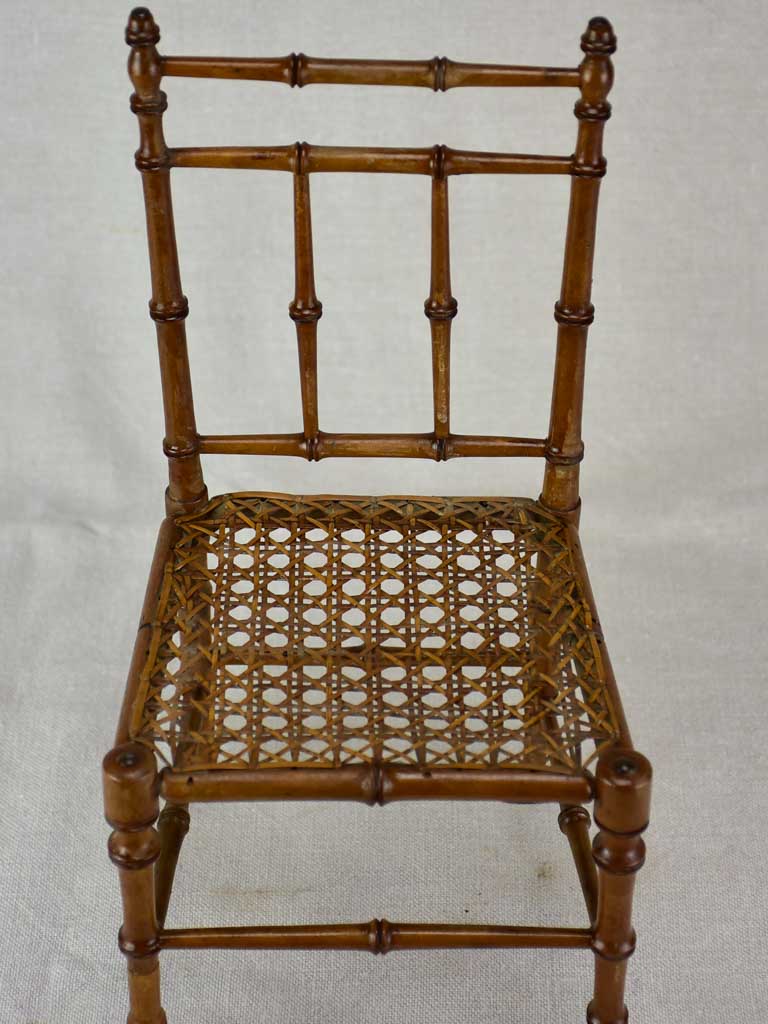 Miniature antique French chair with bamboo frame and cane seat