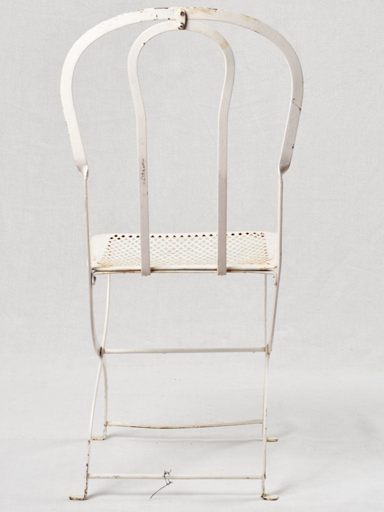 Set of four white folding garden chairs