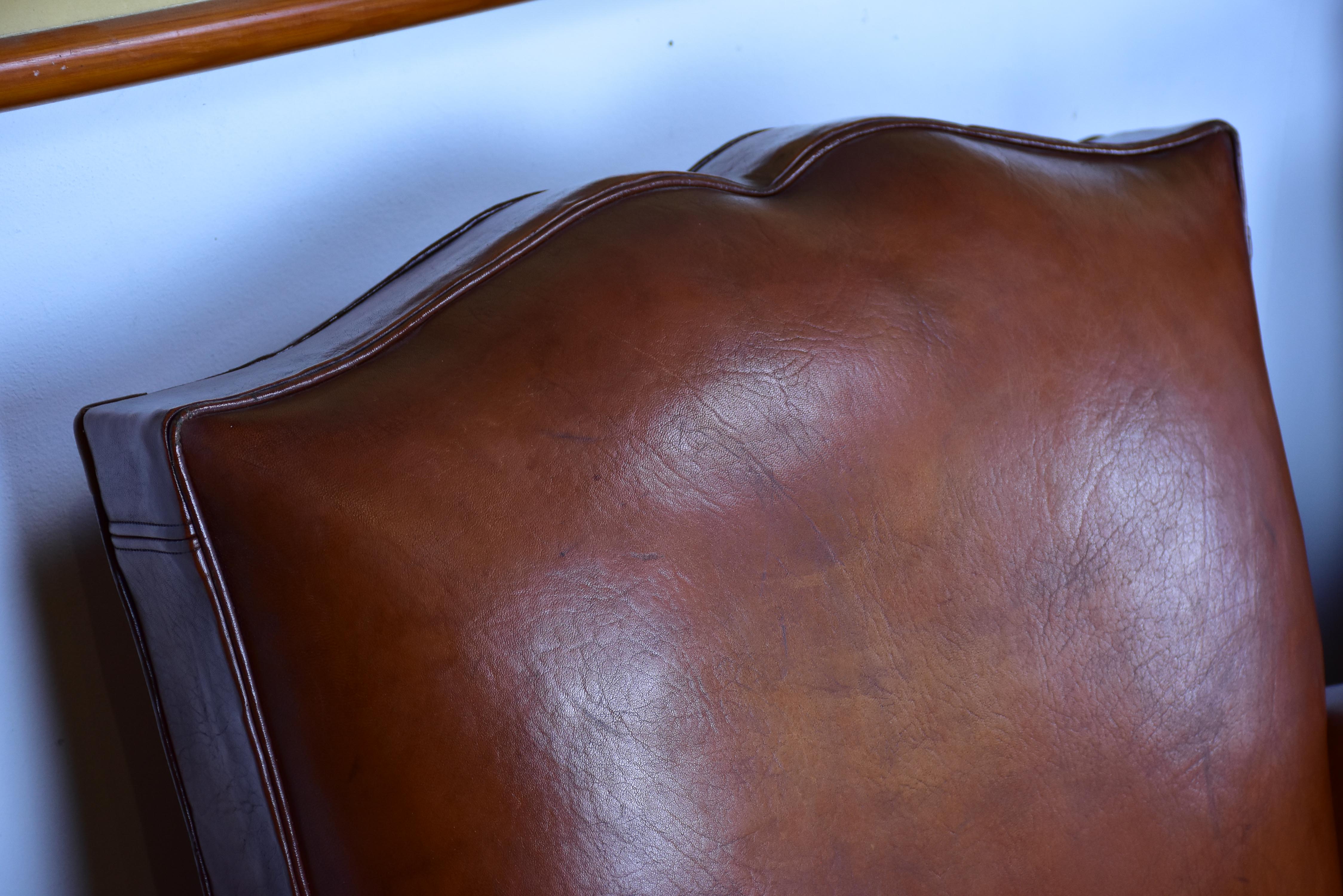 Pair of moustache back French leather club chairs