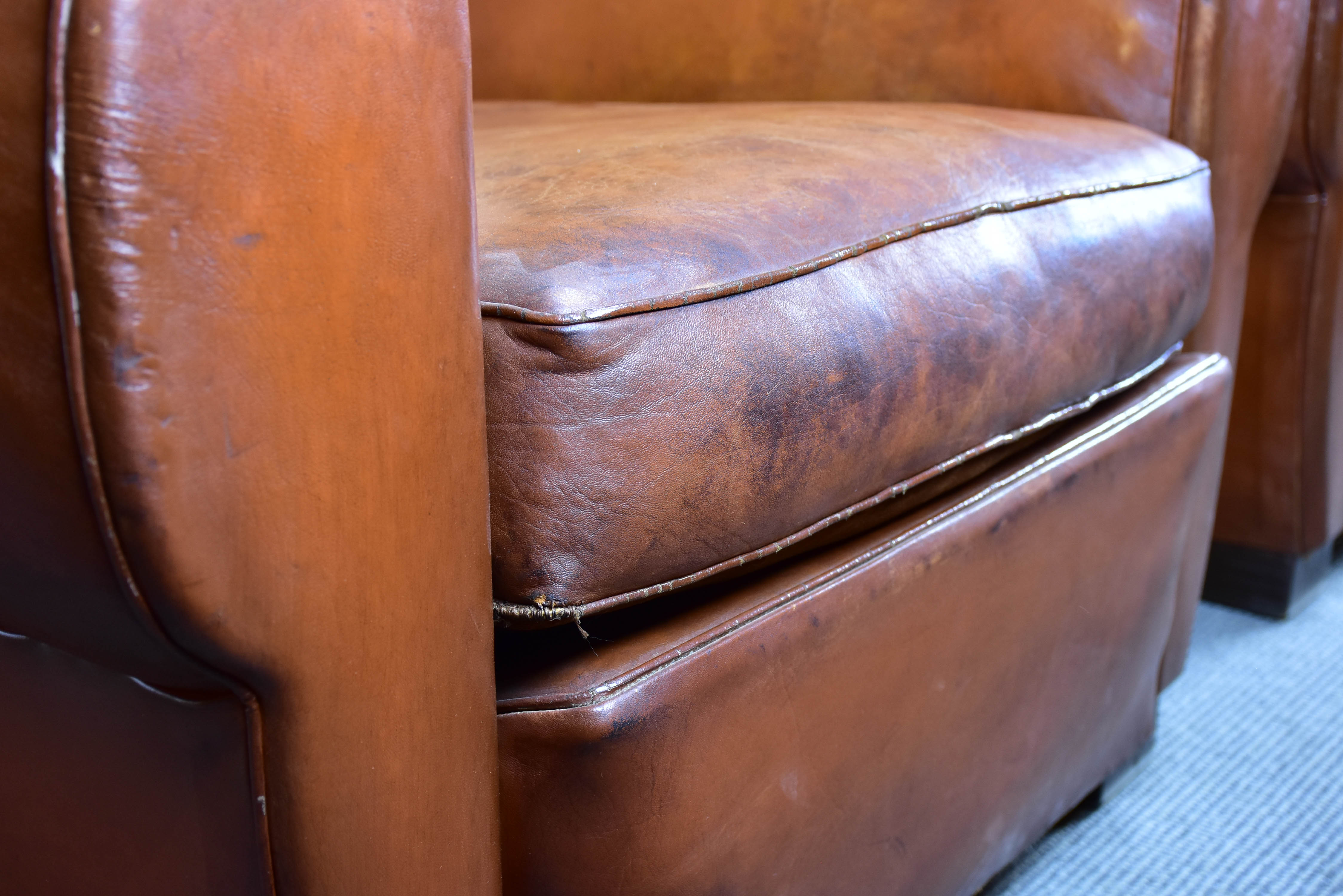 Pair of moustache back French leather club chairs