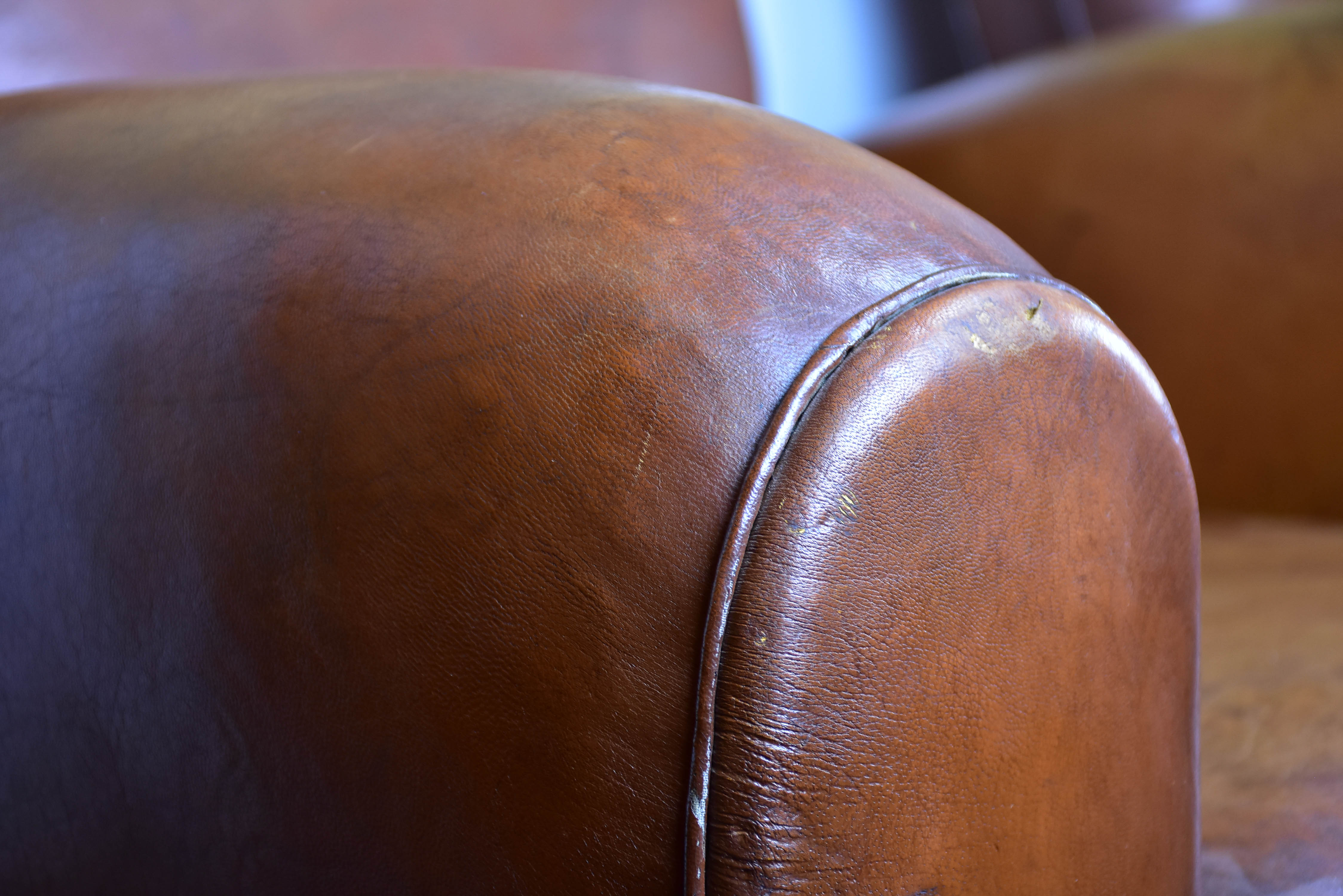 Pair of moustache back French leather club chairs