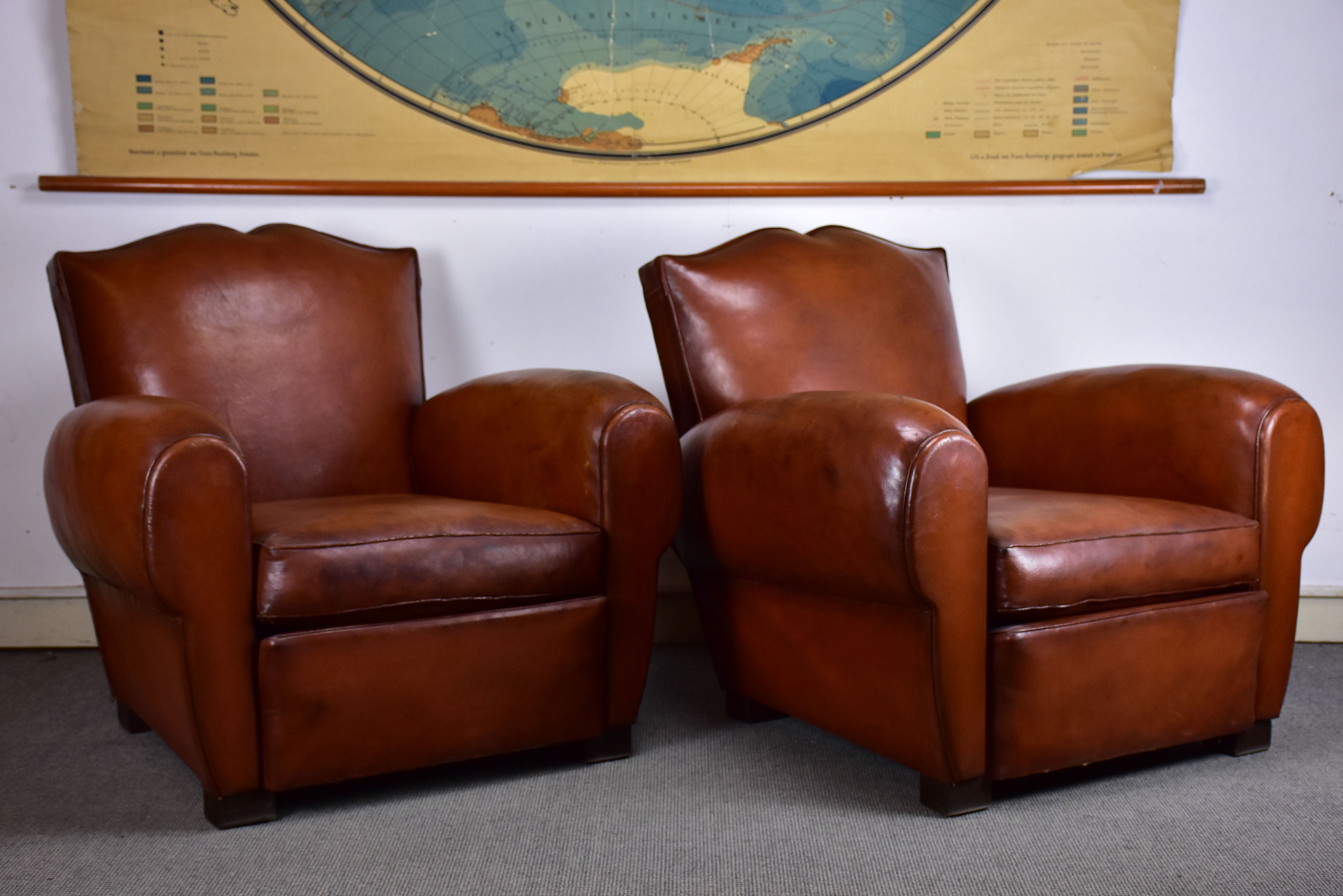 Pair of moustache back French leather club chairs