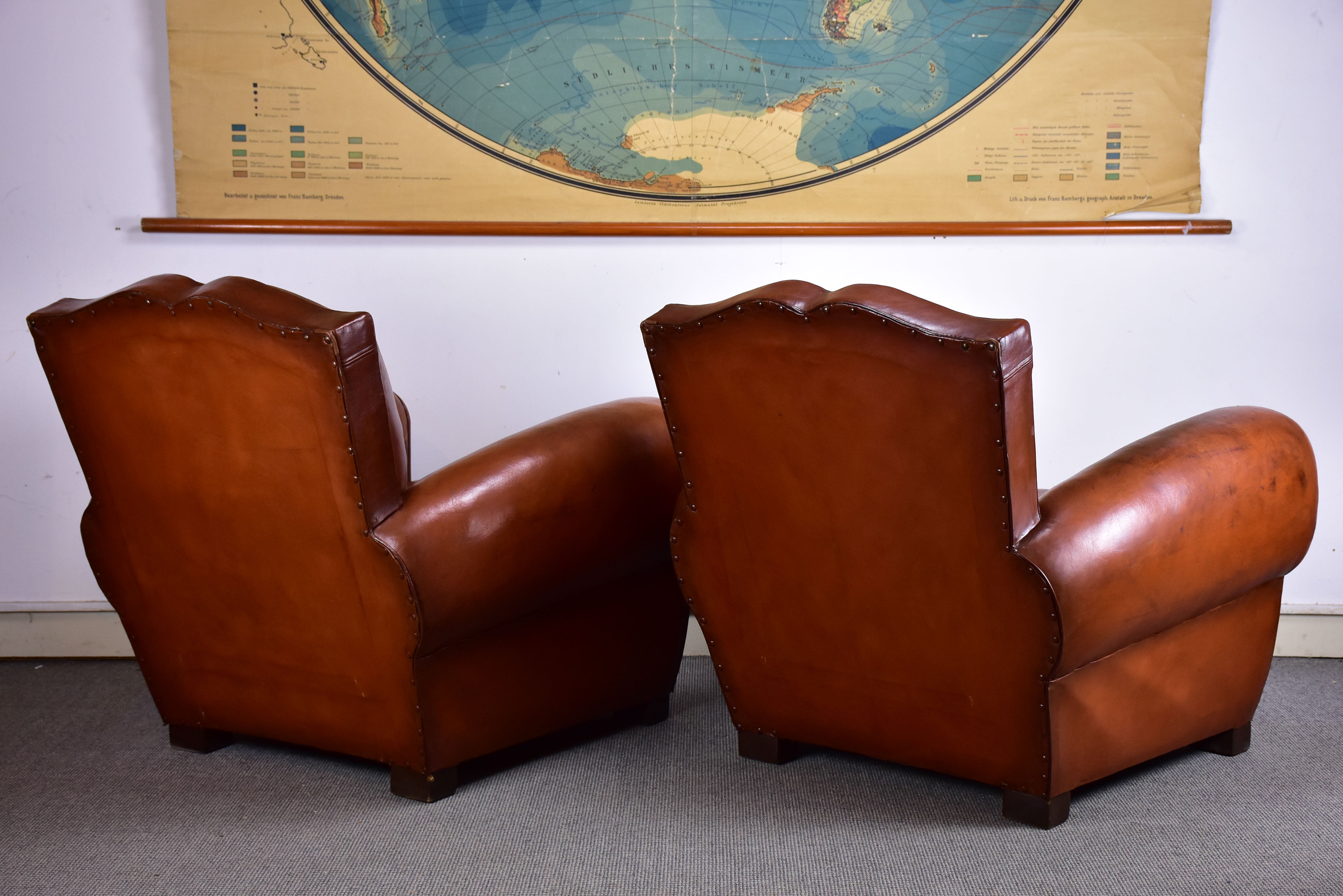Pair of moustache back French leather club chairs