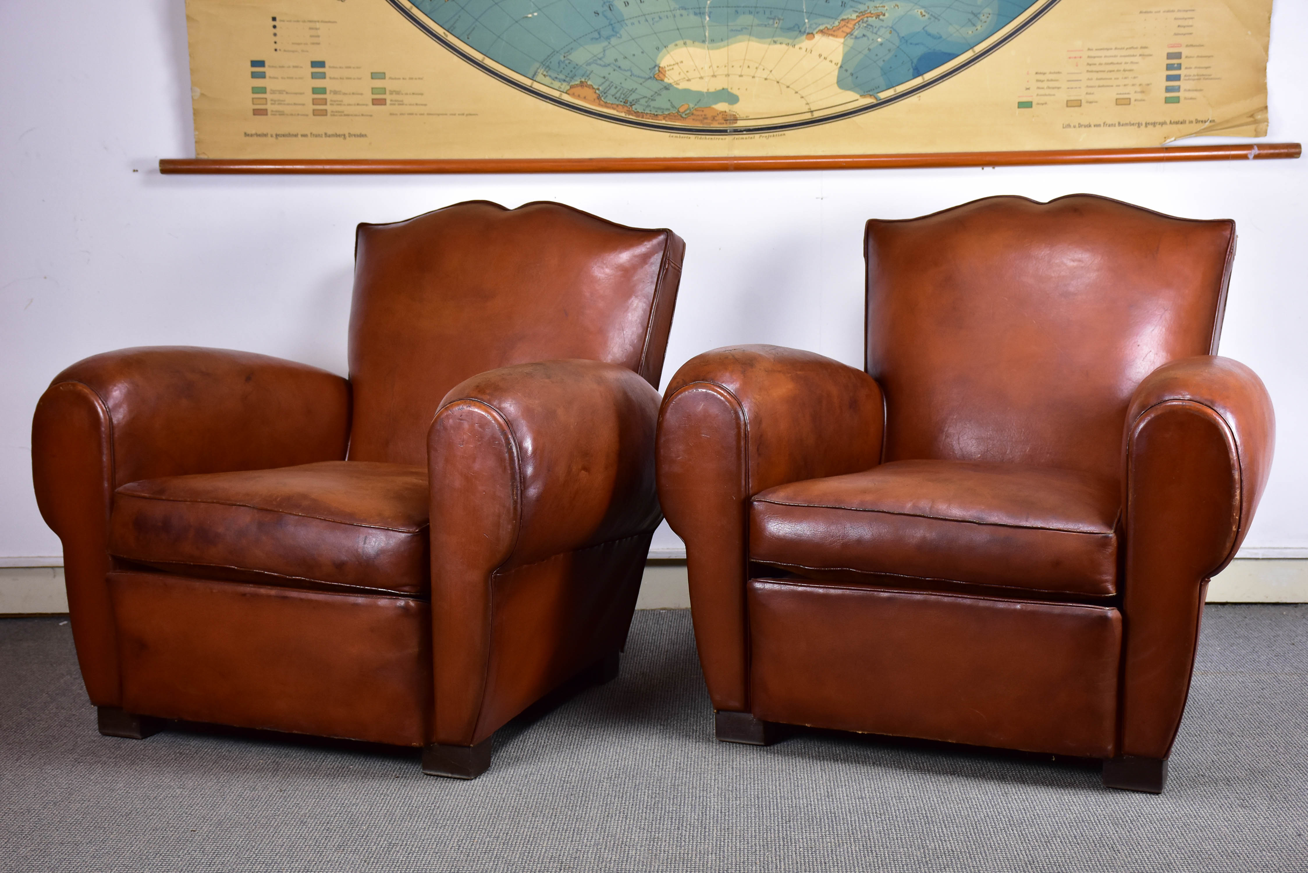 Pair of moustache back French leather club chairs