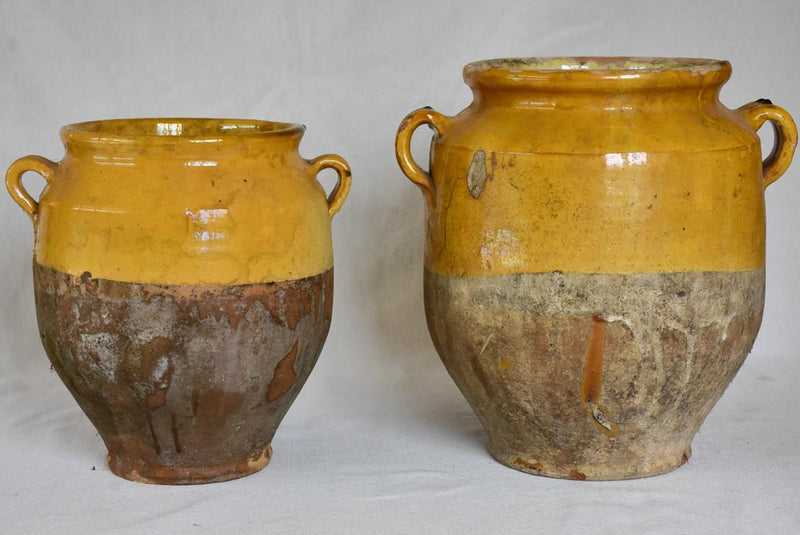 Two large antique French confit pots with yellow glaze