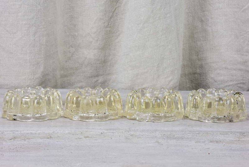 Four antique French glass table risers
