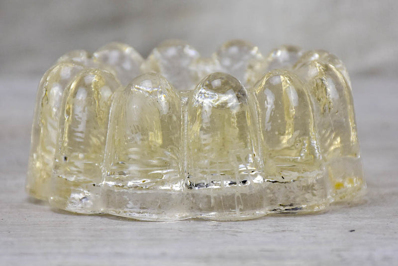 Four antique French glass table risers