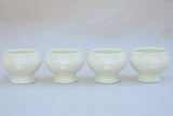 Four miniature earthenware cream bowls