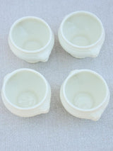 Four miniature earthenware cream bowls