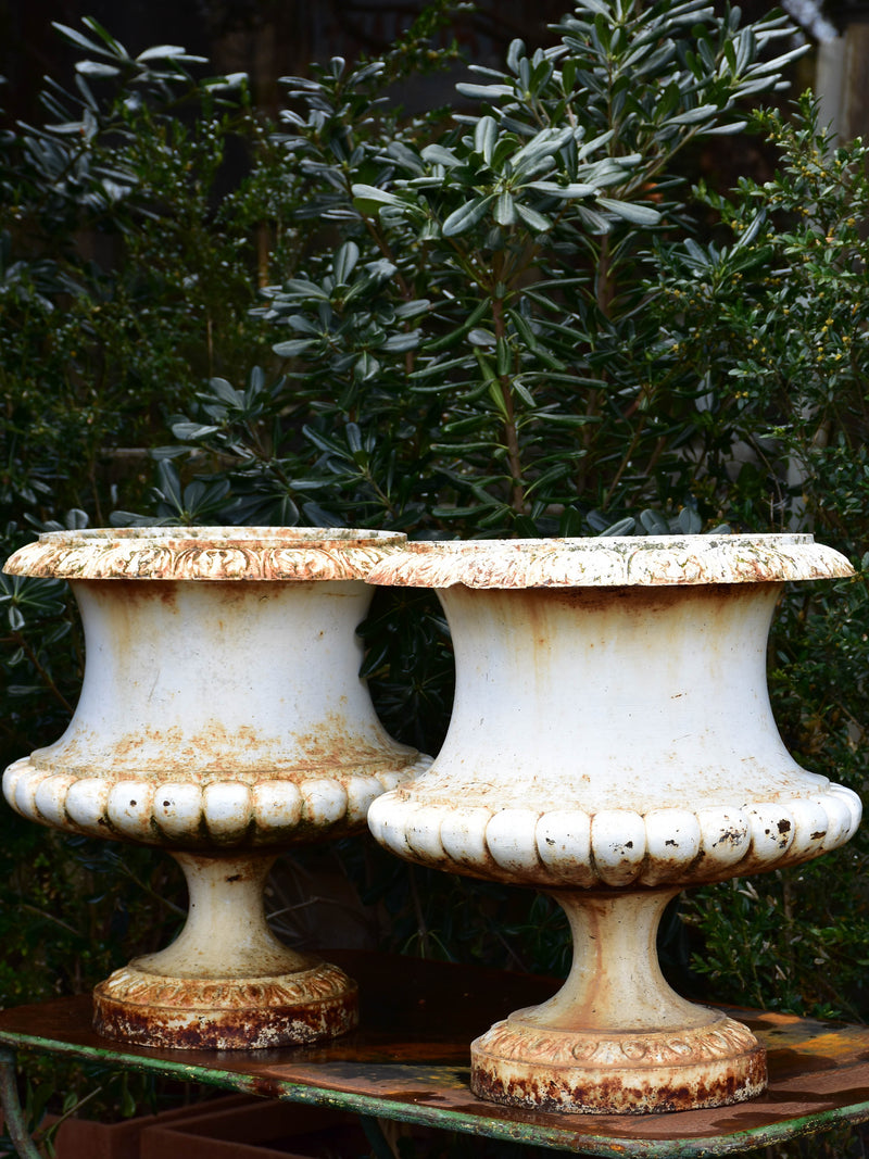 Two large antique French garden urns with white finish