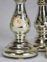 Three mercury glass candlesticks with flowers