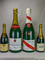 Collection of four oversize advertising champagne bottles - 1950s
