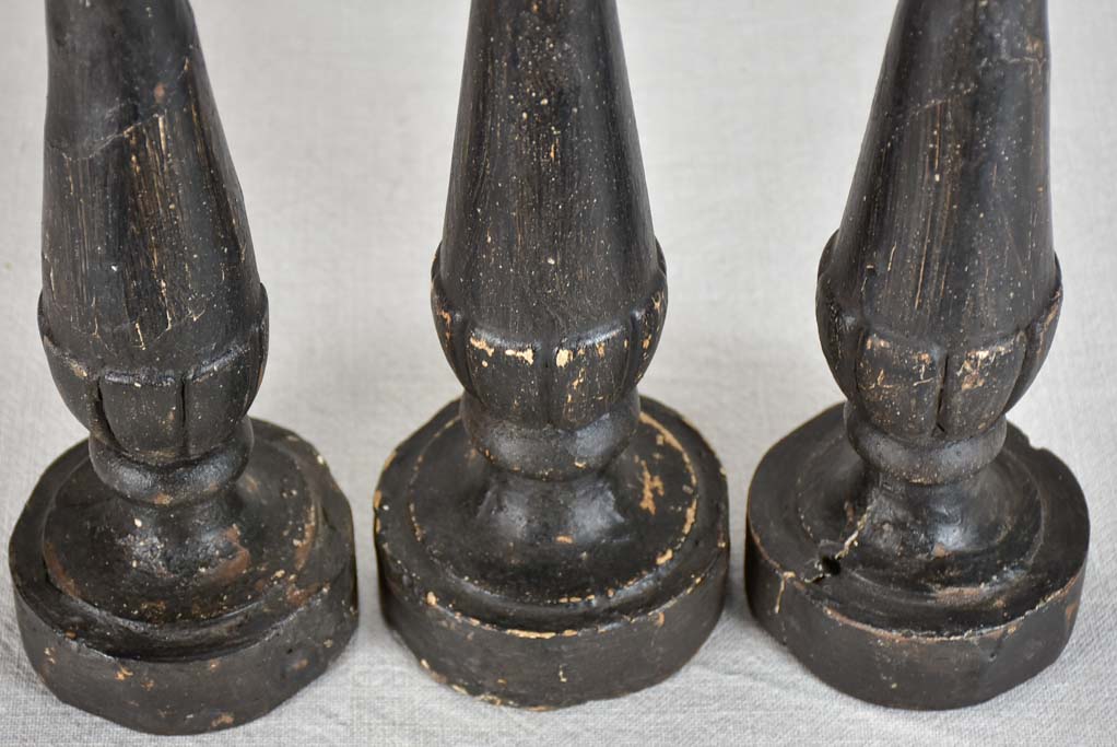 Three twentieth-century French wooden candlesticks with black paint finish 15"