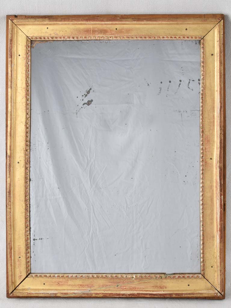 Gilded Louis XVI mirror with running pearl and mercury glass 28" x 20¾"