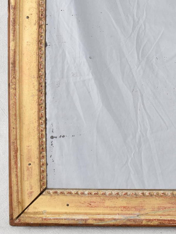 Gilded Louis XVI mirror with running pearl and mercury glass 28" x 20¾"